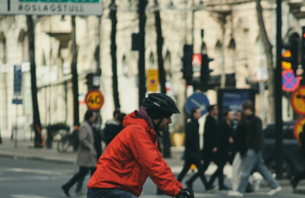 Cyclist wearing a helmet riding through a city street